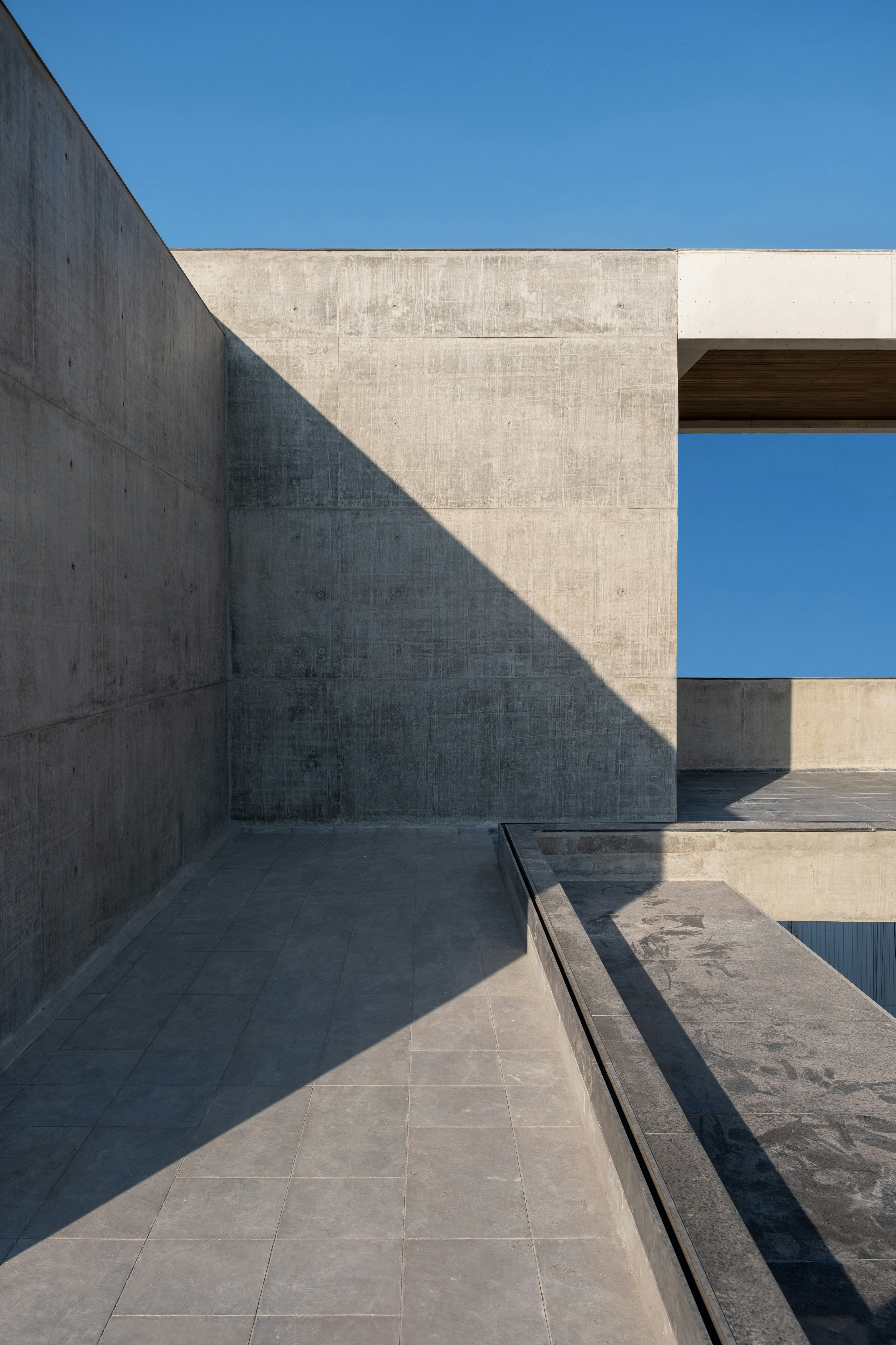 Minimal concrete architecture with geometric light and shadow